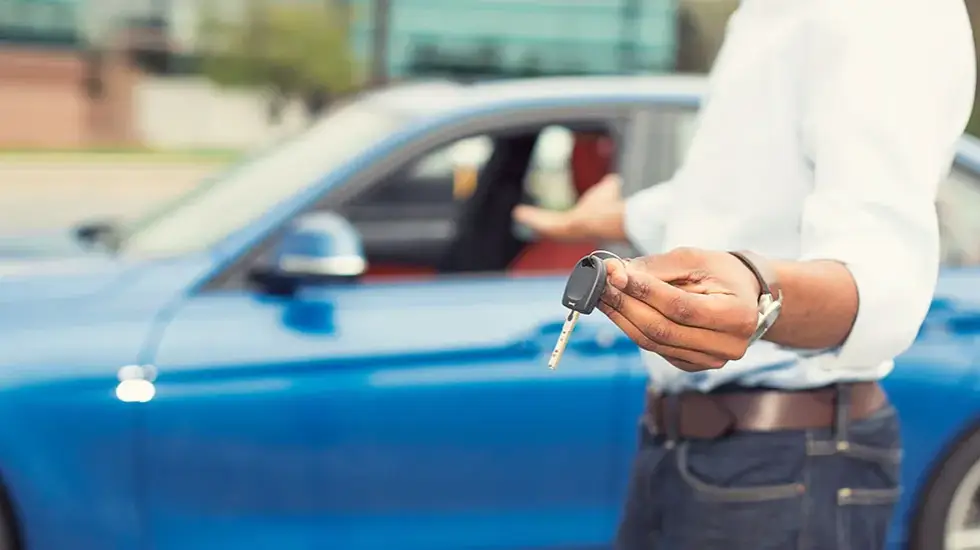 Driver holding car keys ready to sell a car in Hobart.