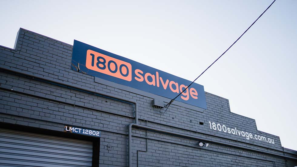 1800 Salvage building with blue and orange signage on brick exterior