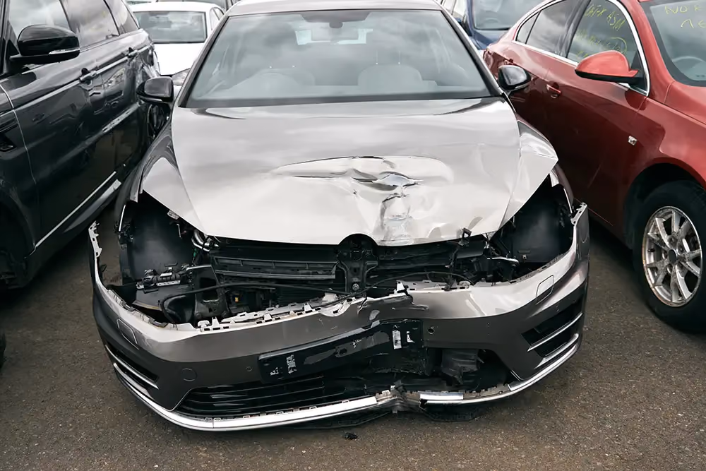 A written-off car with a totally smashed front.