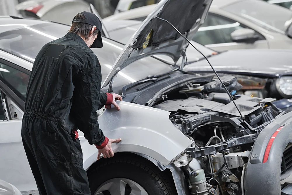 Mechanic taking apart a car