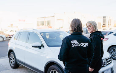 Salvage expert discussing trading in a non-running car with customer