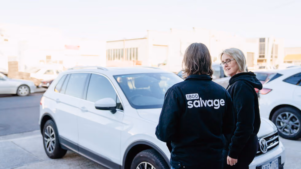 Salvage expert discussing trading in a non-running car with customer