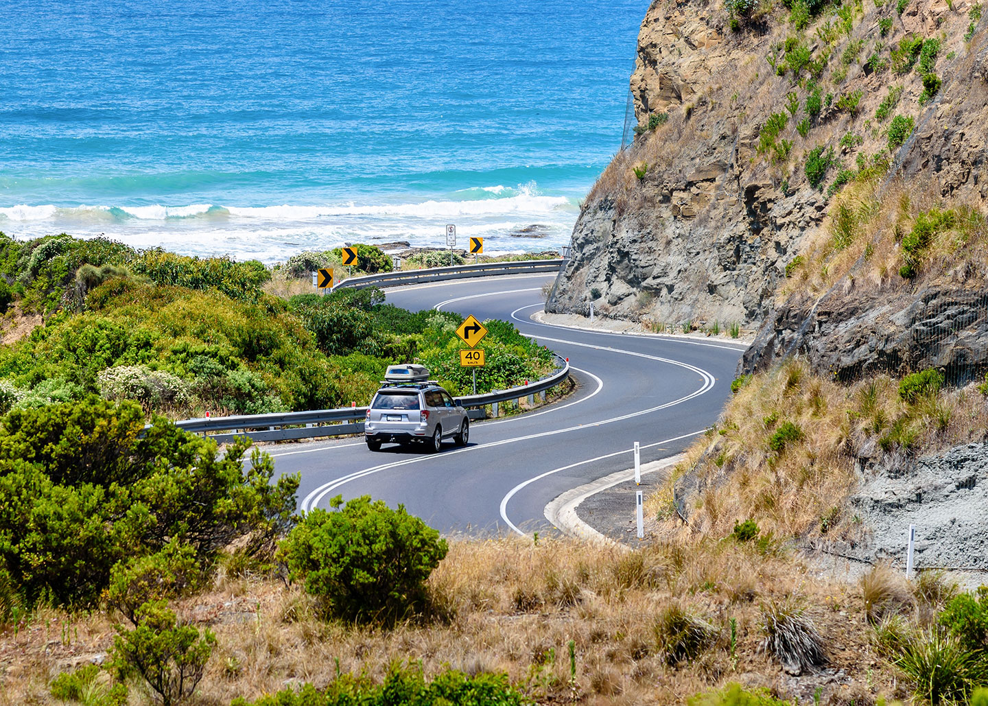 A car driving on the Great Ocean Road, Victoria, Australia