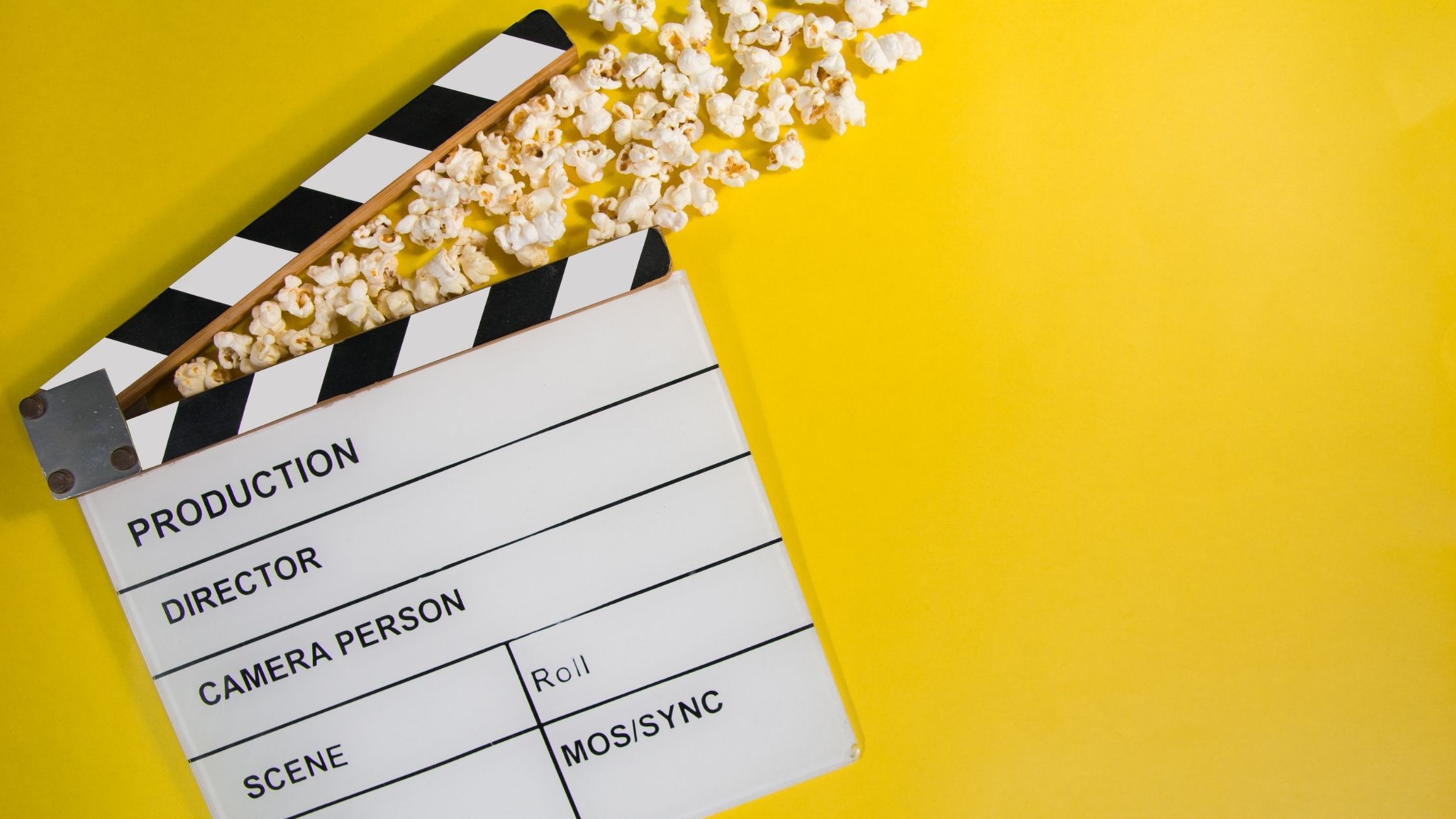 Popcorn and a movie clacker - set to a Yellow backdrop
