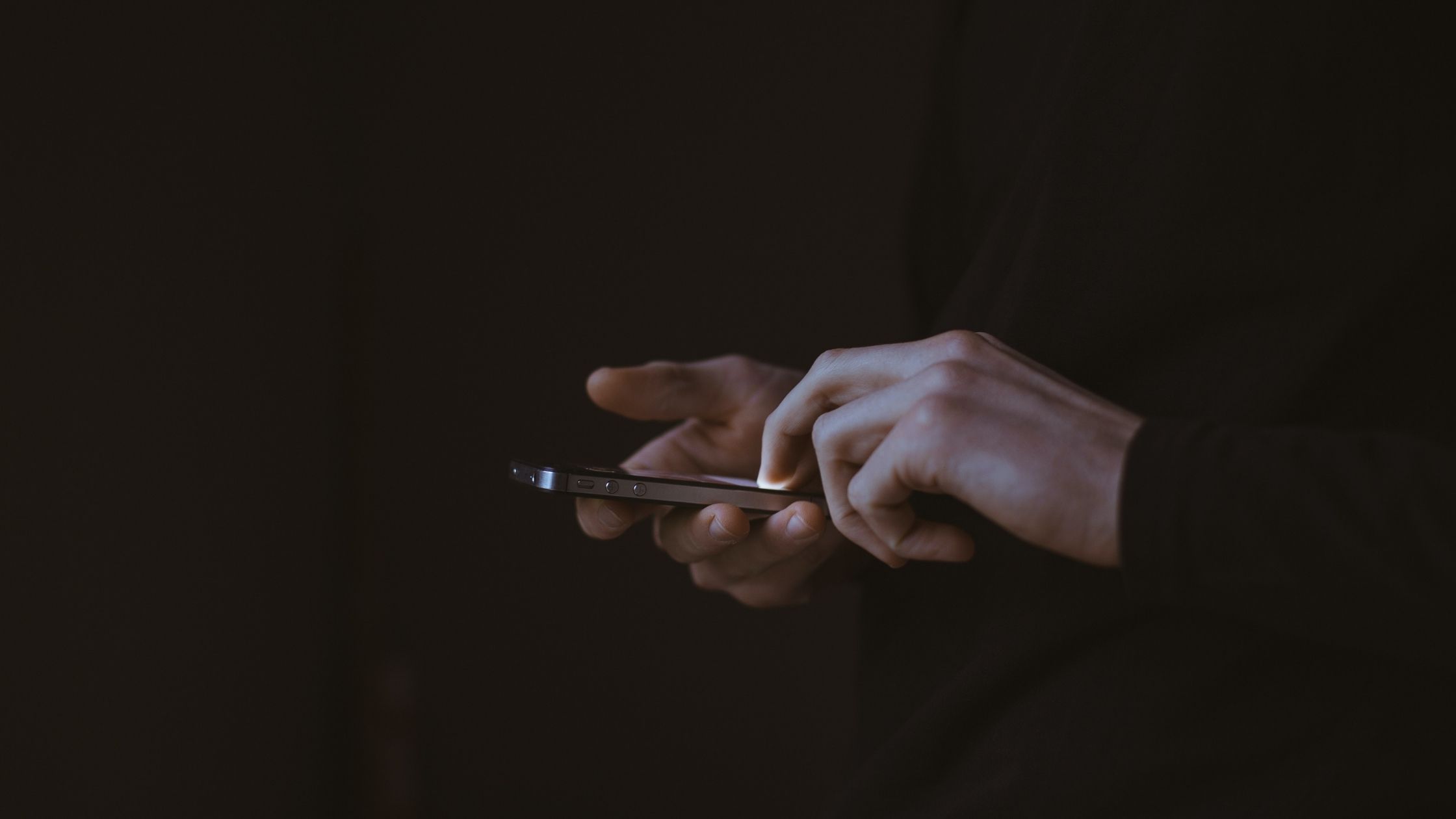 A Man Types On A Phone