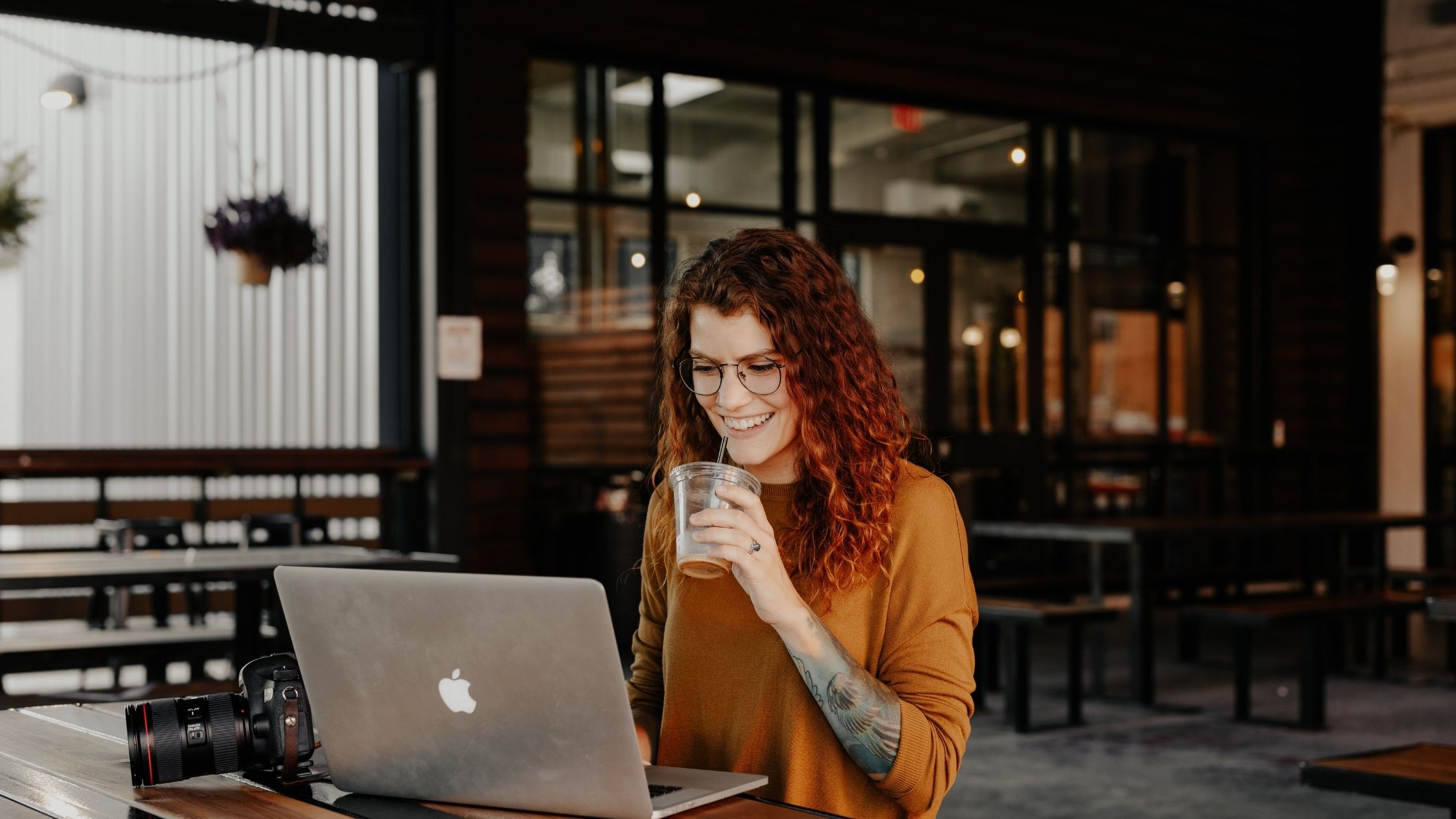 A woman in a coffee shop on her laptop