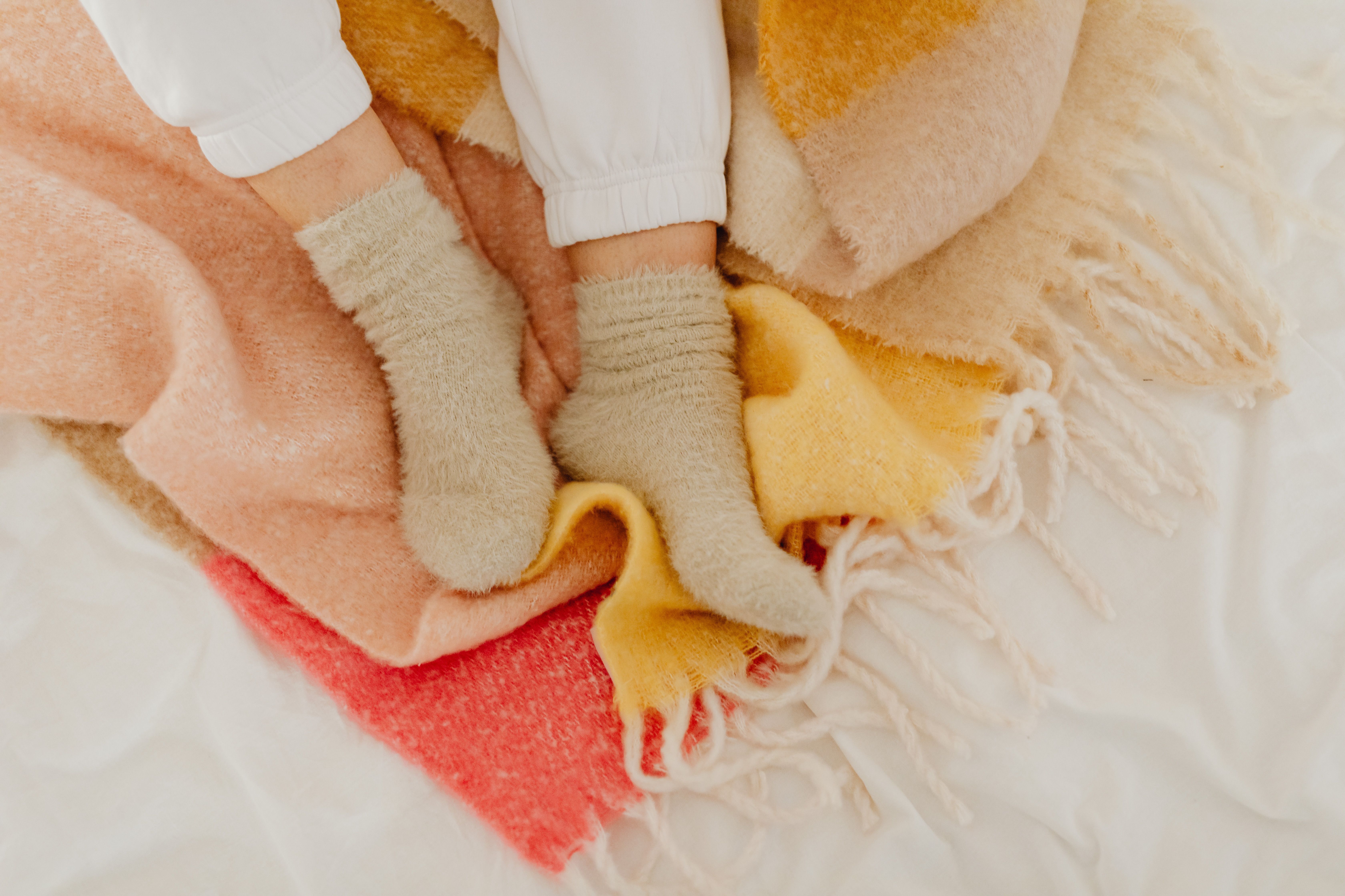 Comforting scene of socks and blankets conveying warmth and relaxation