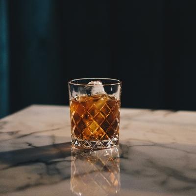 A glass of whiskey on a marble table