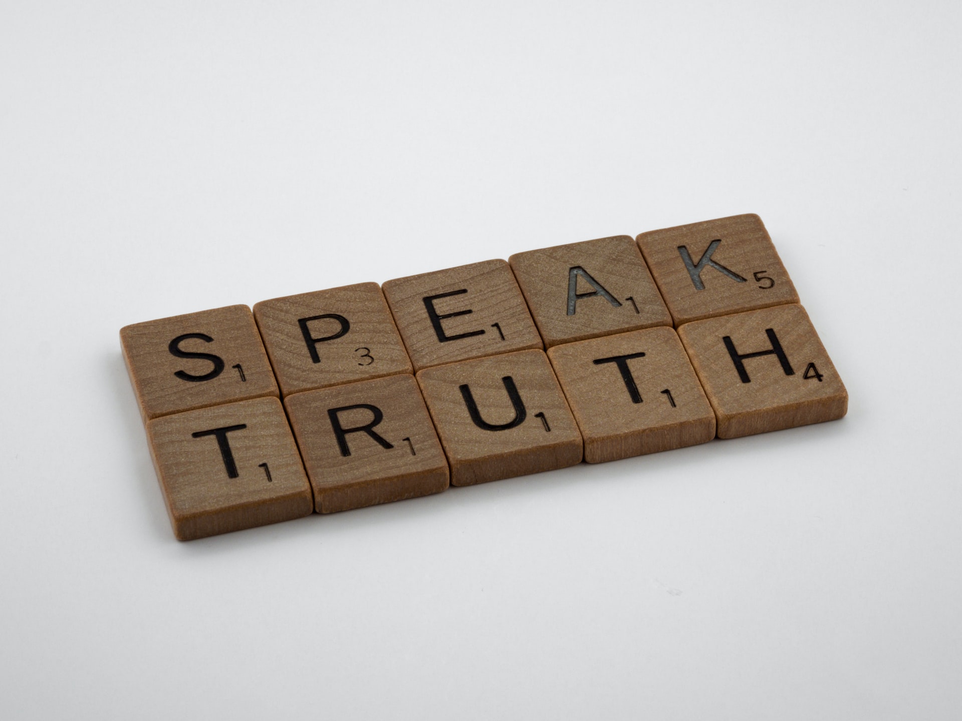 A wooden sign which read 'speak truth'