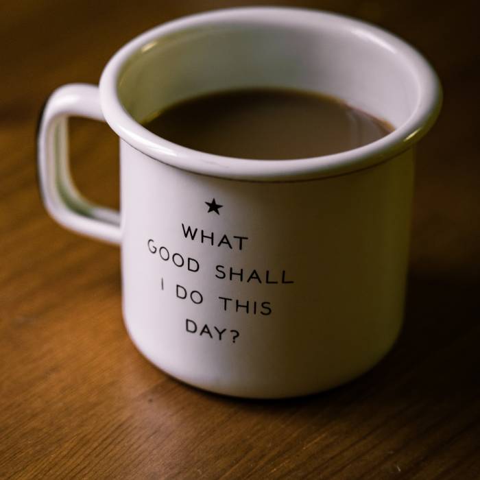 A mug of coffee with 'what good shall i do this day' written on the side