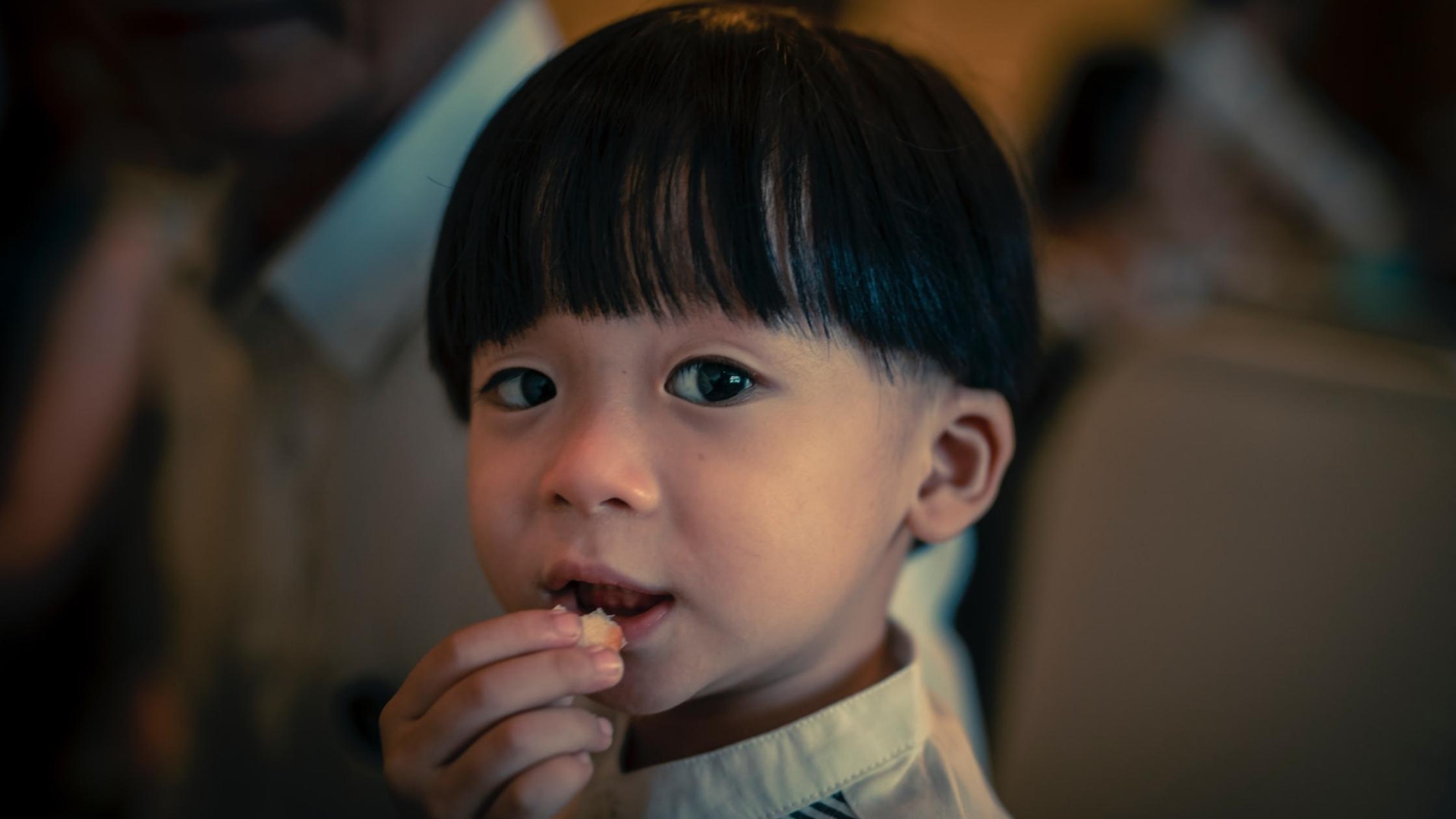 A Toddler eating Bread
