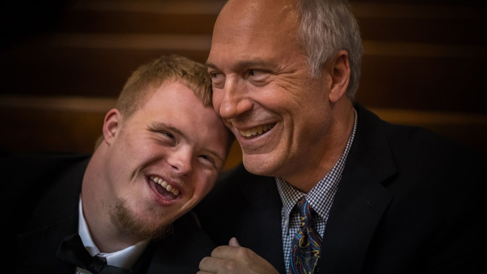A Dad and son laughing together 