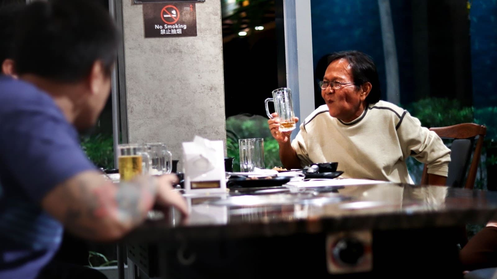 Man holding a beer and smiling 