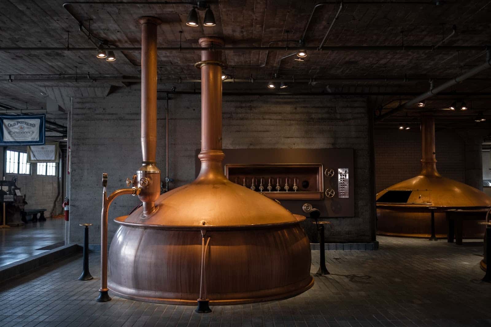 Two brass brewery tanks 