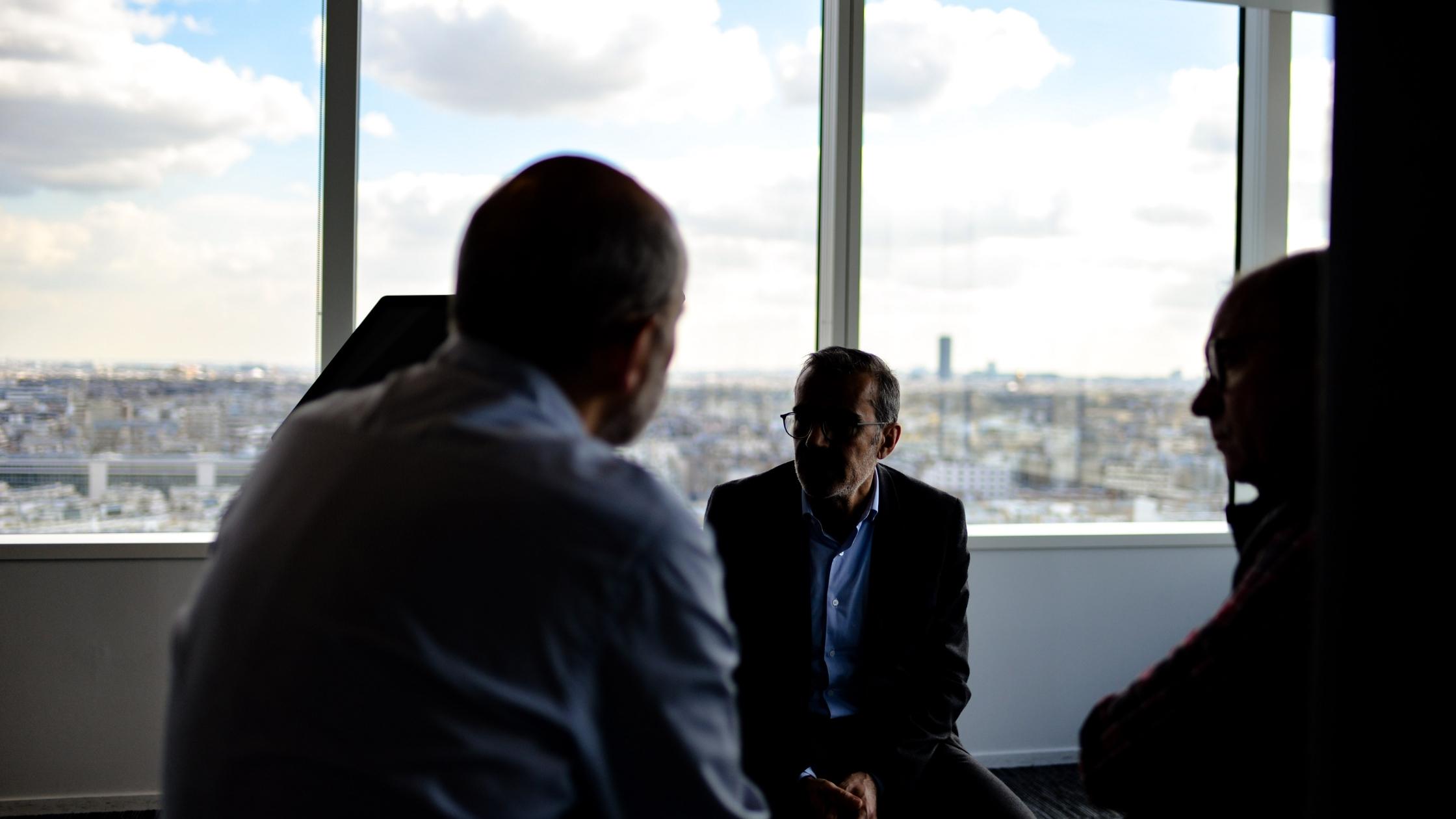Three colleagues are in conversation
