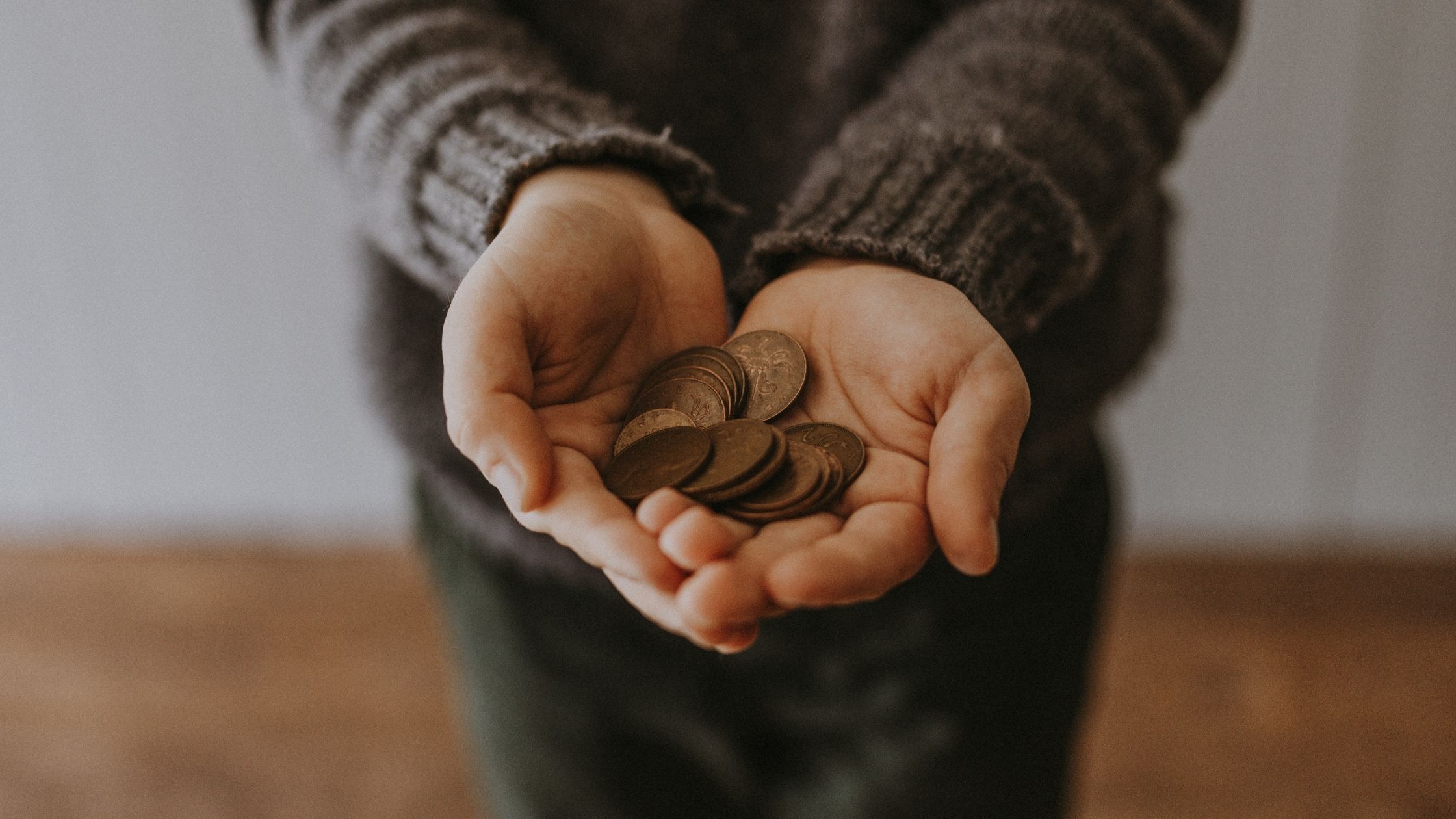 An outstretched pair of hands asking for money