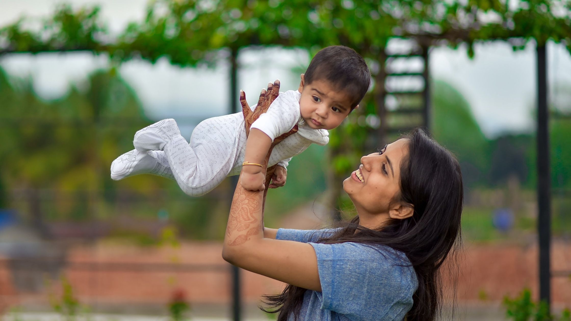 A mother holds her baby. 