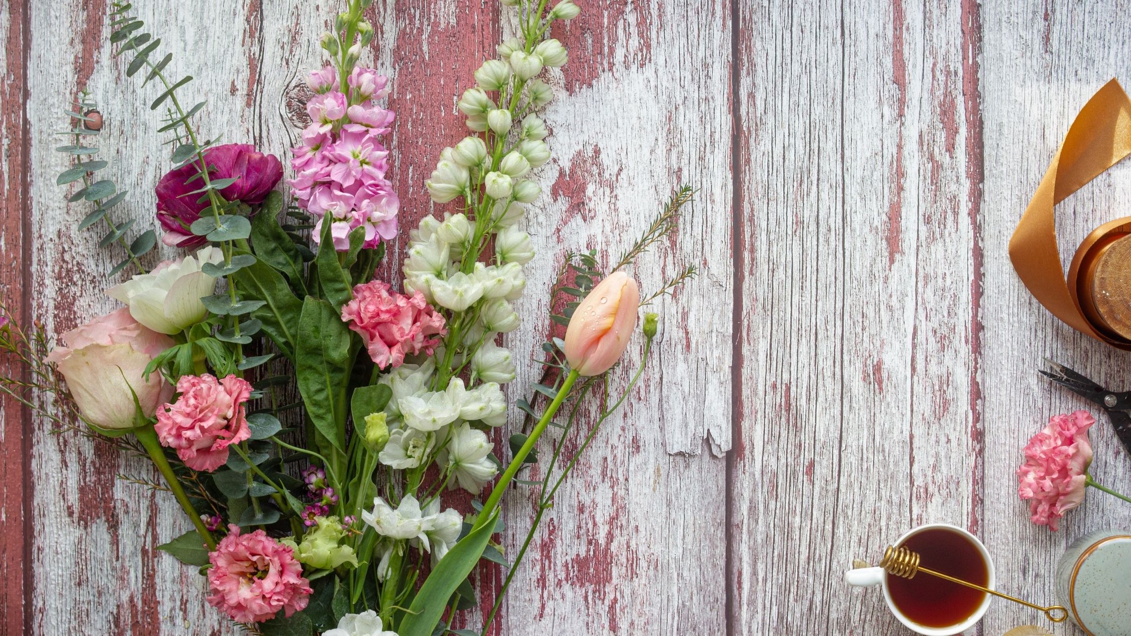 A pastel bunch of flowers on a wooden table