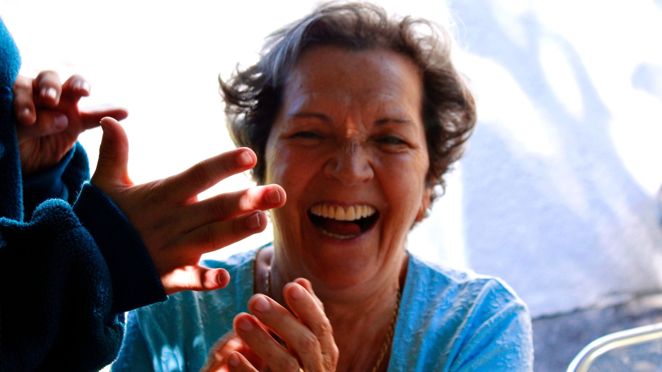 A mother laughs into the camera