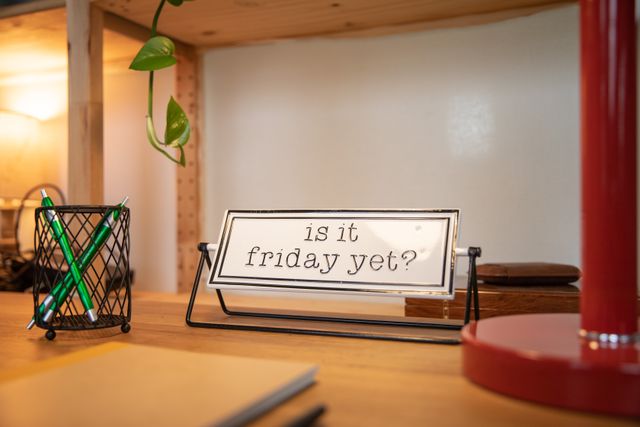 A desk sign that reads "is it friday yet?"