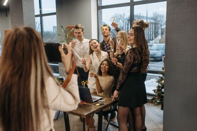 Colleagues taking a picture together at the office Christmas party. 