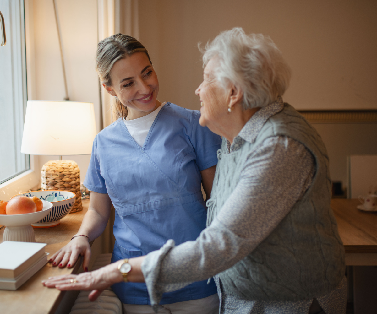 Healthcare professional providing private home care to an older adult at home