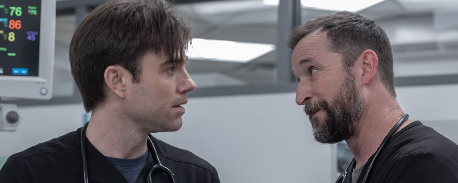 Dr. Langdon and Dr. Robby stand face to face in the trauma room in a heated discussion. Image courtesy of Warrick Page/MAX.