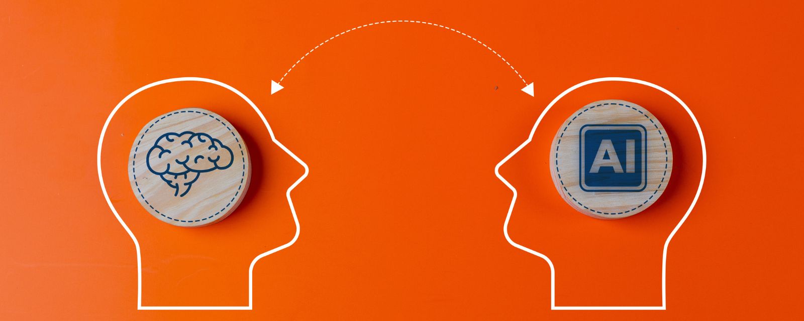 Drawn outline of two heads facing each other with an arrow arching over them connecting them one head has a brain and the other has AI.