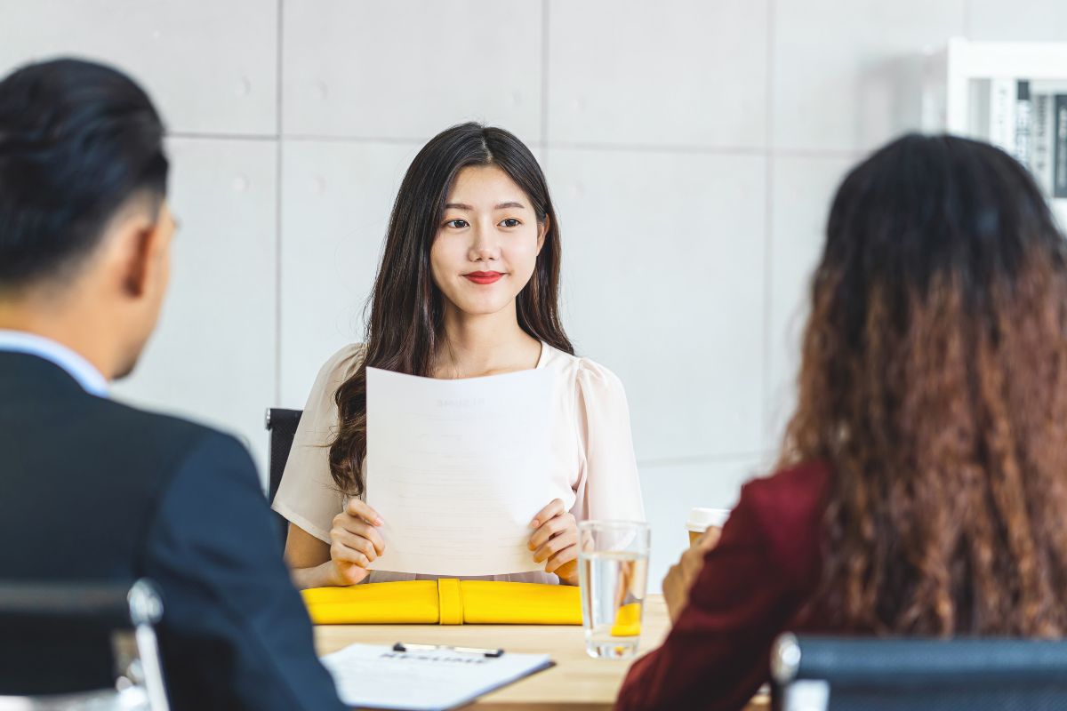 Young Asian woman graduate holding the resume document and preparing to two manager before start to job interview