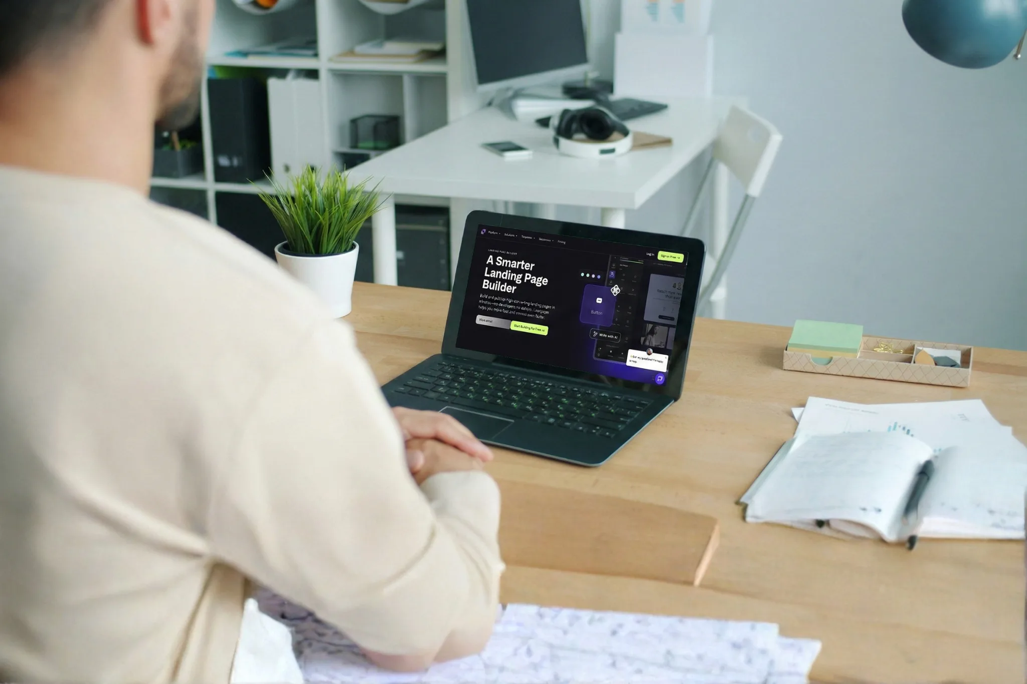 A person at a desk viewing the Leadpages landing page builder on a laptop, with the headline A Smarter Landing Page Builder