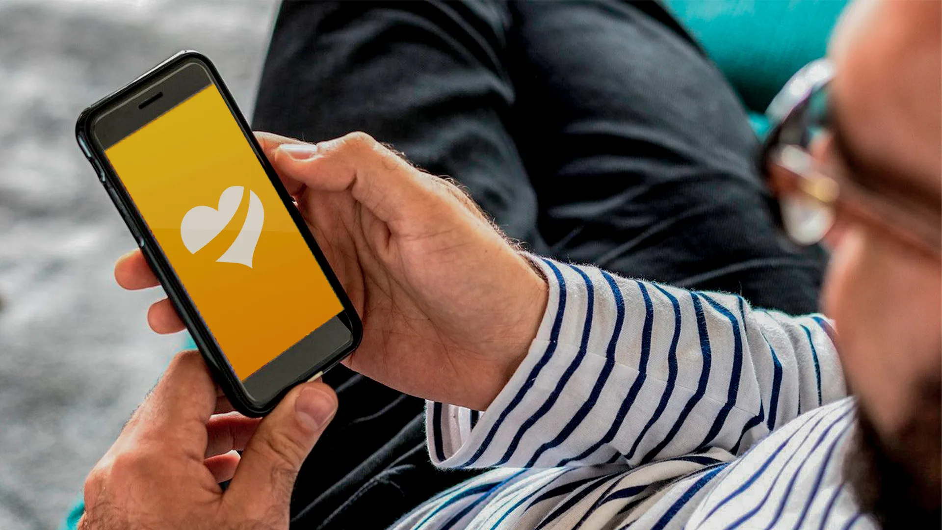 A person holding a phone with the Taste app open on the splash screen