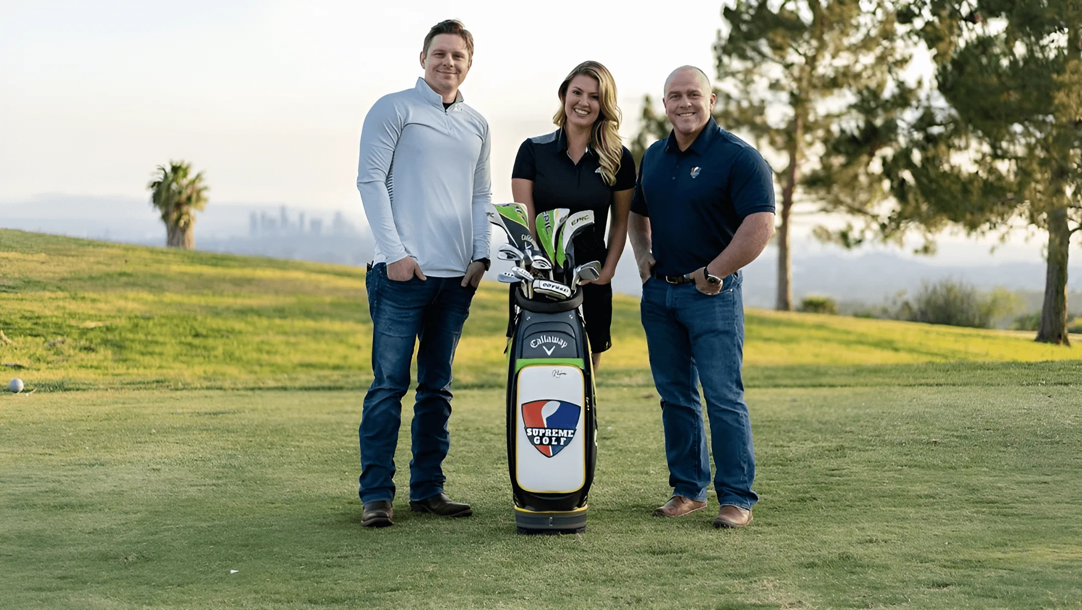 The CEO of Supreme Golf with two people and golf clubs at a golf course