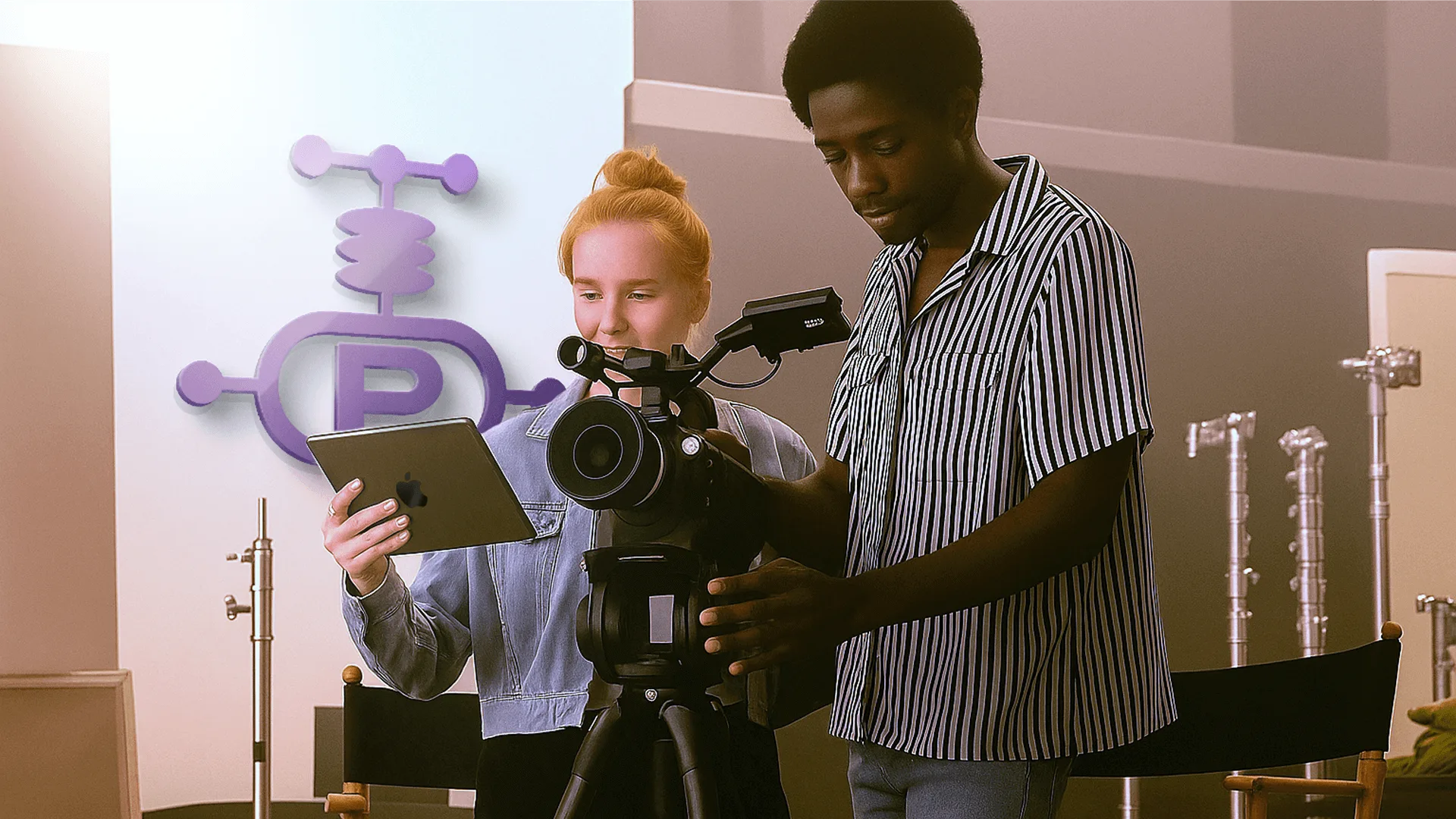 Two crew members on a film set reviewing a shot on an iPad next to a camera, under the PacPost logo