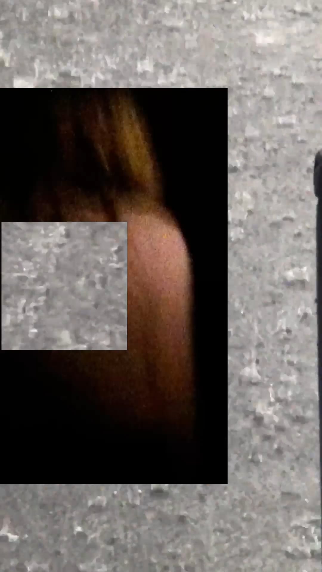 Blurred close-up of a woman’s shoulder overlaid with grainy static textures.