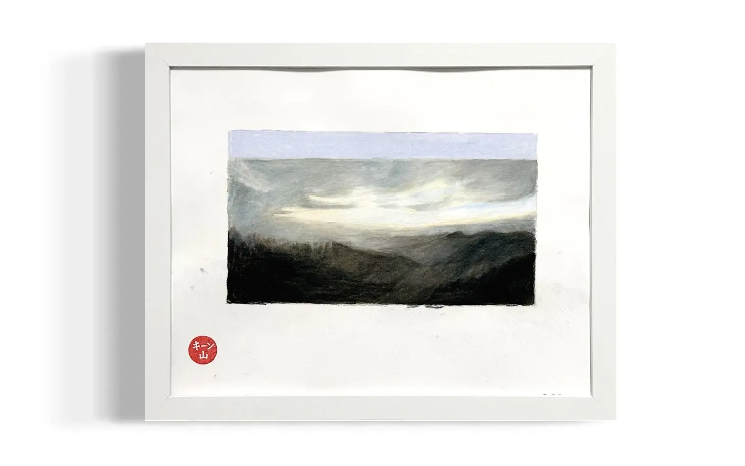 Muted mountain landscape with pale clouds drifting over layered hills at dusk.