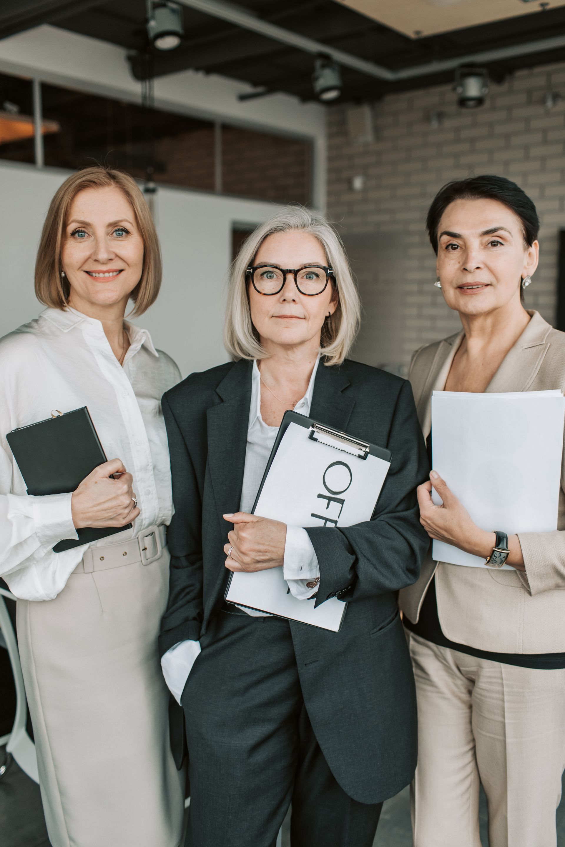 Group of senior female professionals confidently posing in office setting. Photo by Vlada Karpovich via Pexels.com