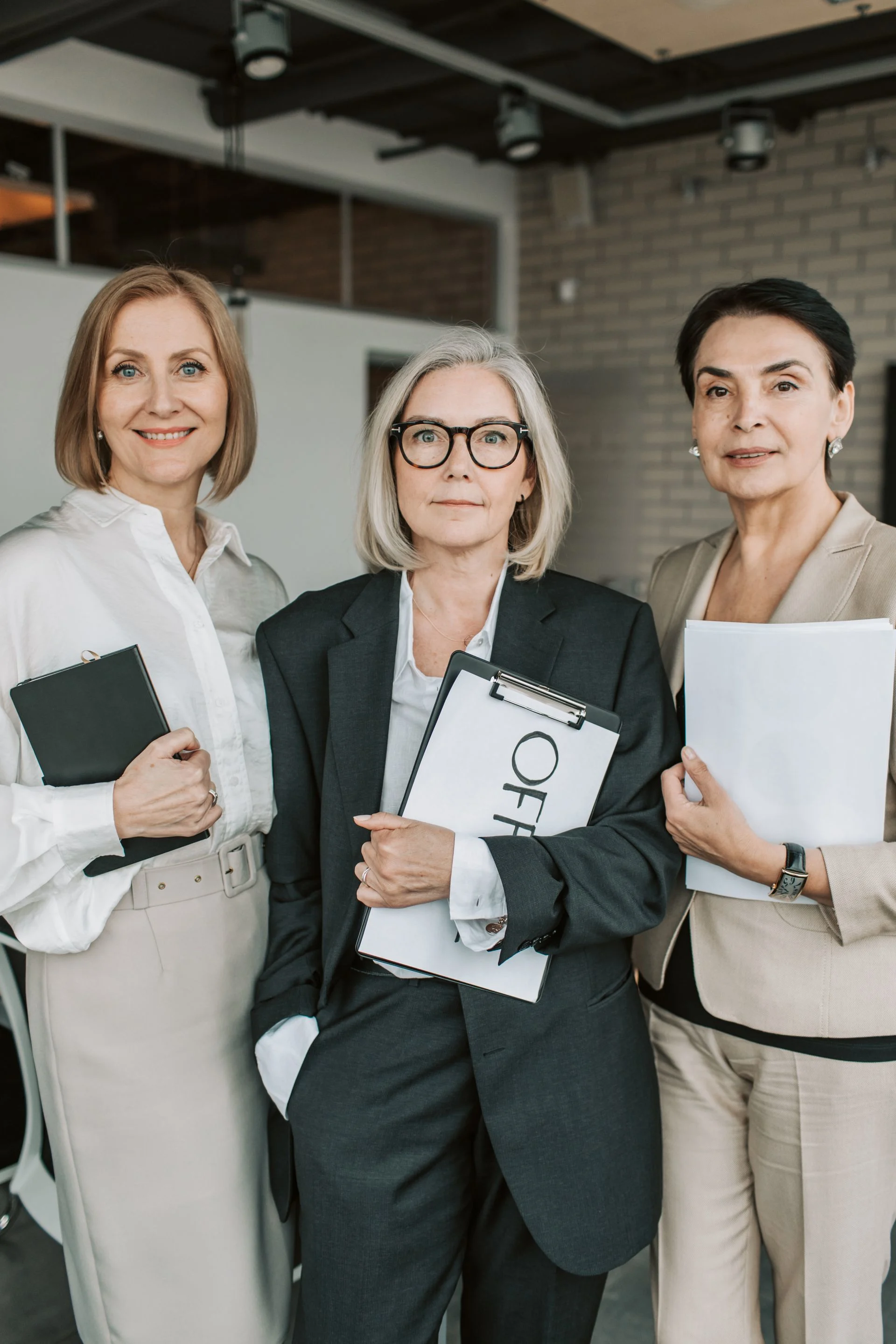 Group of senior female professionals confidently posing in office setting. Photo by Vlada Karpovich via Pexels.com
