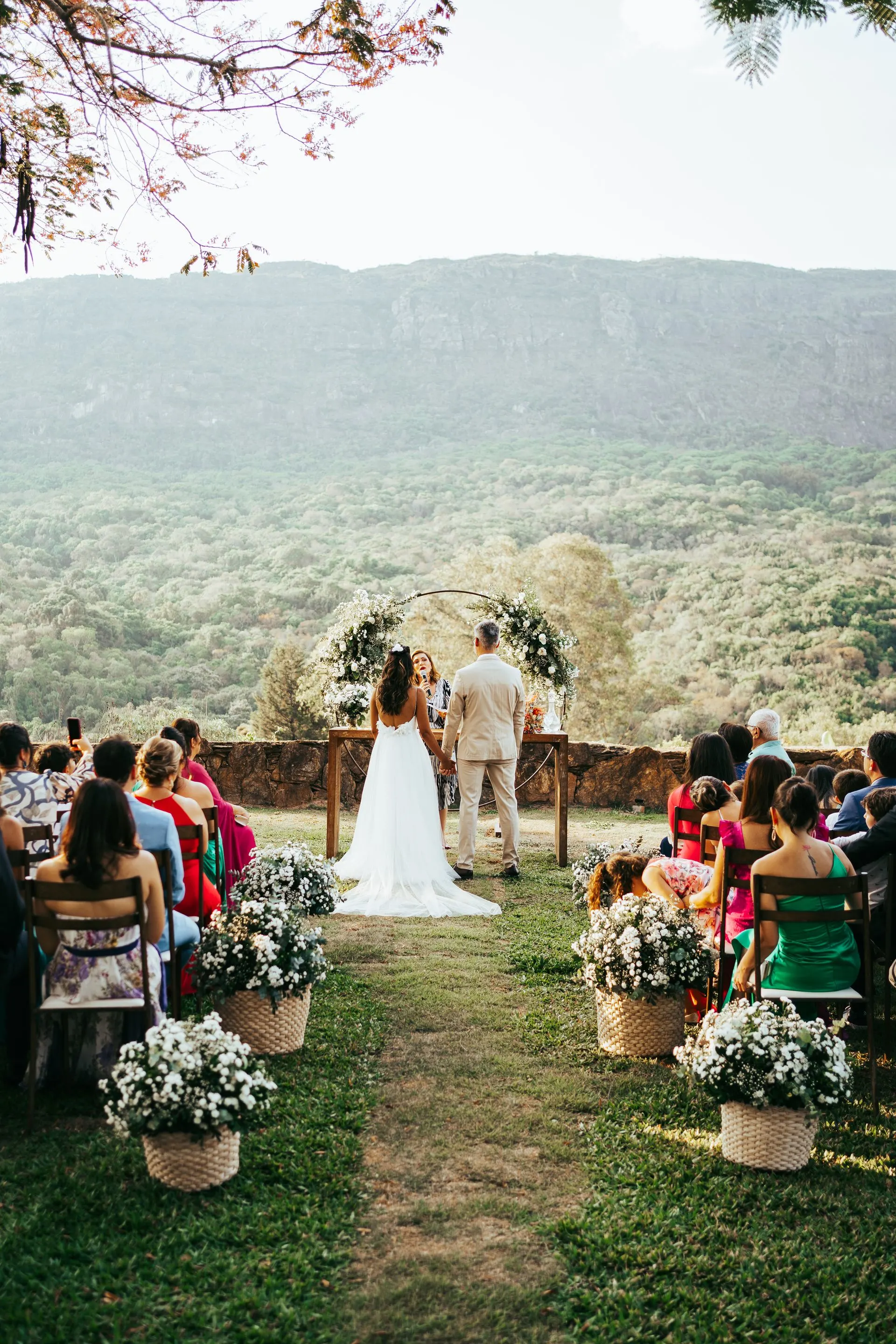 A beautiful outdoor wedding ceremony with a scenic mountain backdrop in Tiradentes, Brazil. Photo by Douglas Mendes via Pexels.com