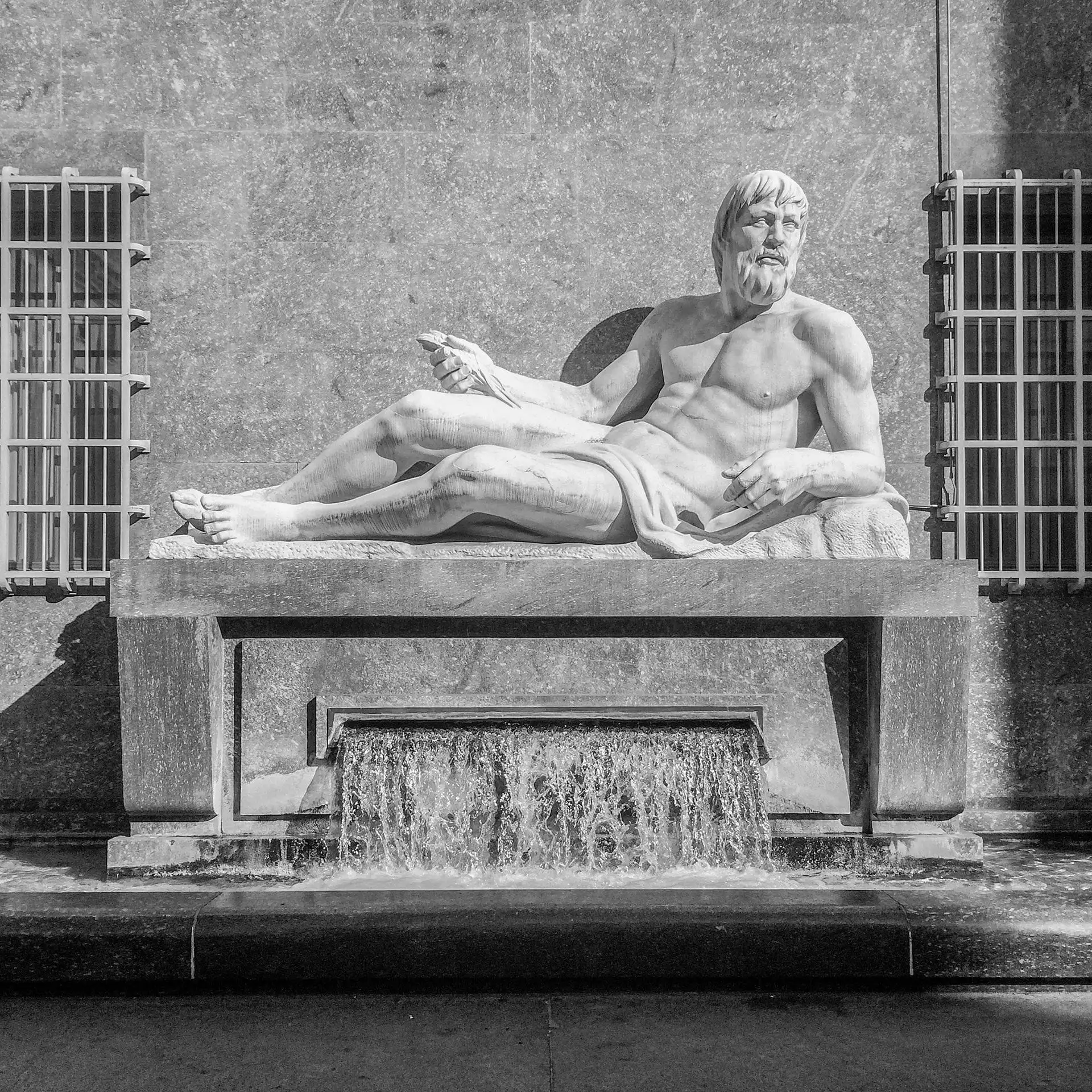 Monochrome image of a classic statue with a flowing water fountain in Turin, Italy. Photo by antonio filigno via Pexels.com