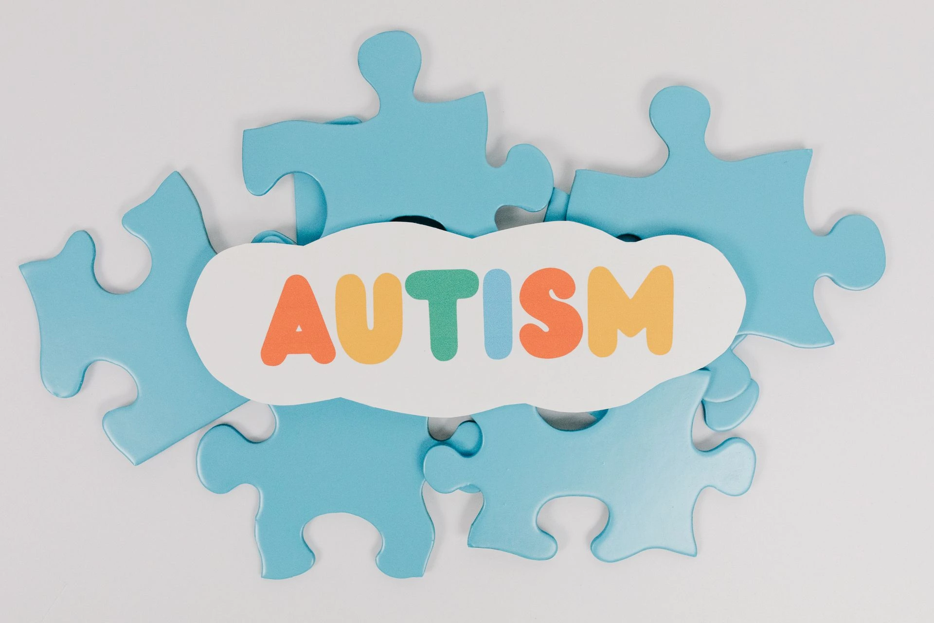 Colorful puzzle pieces with 'AUTISM' text symbolizing autism awareness. Photo by Tara Winstead via Pexels.com