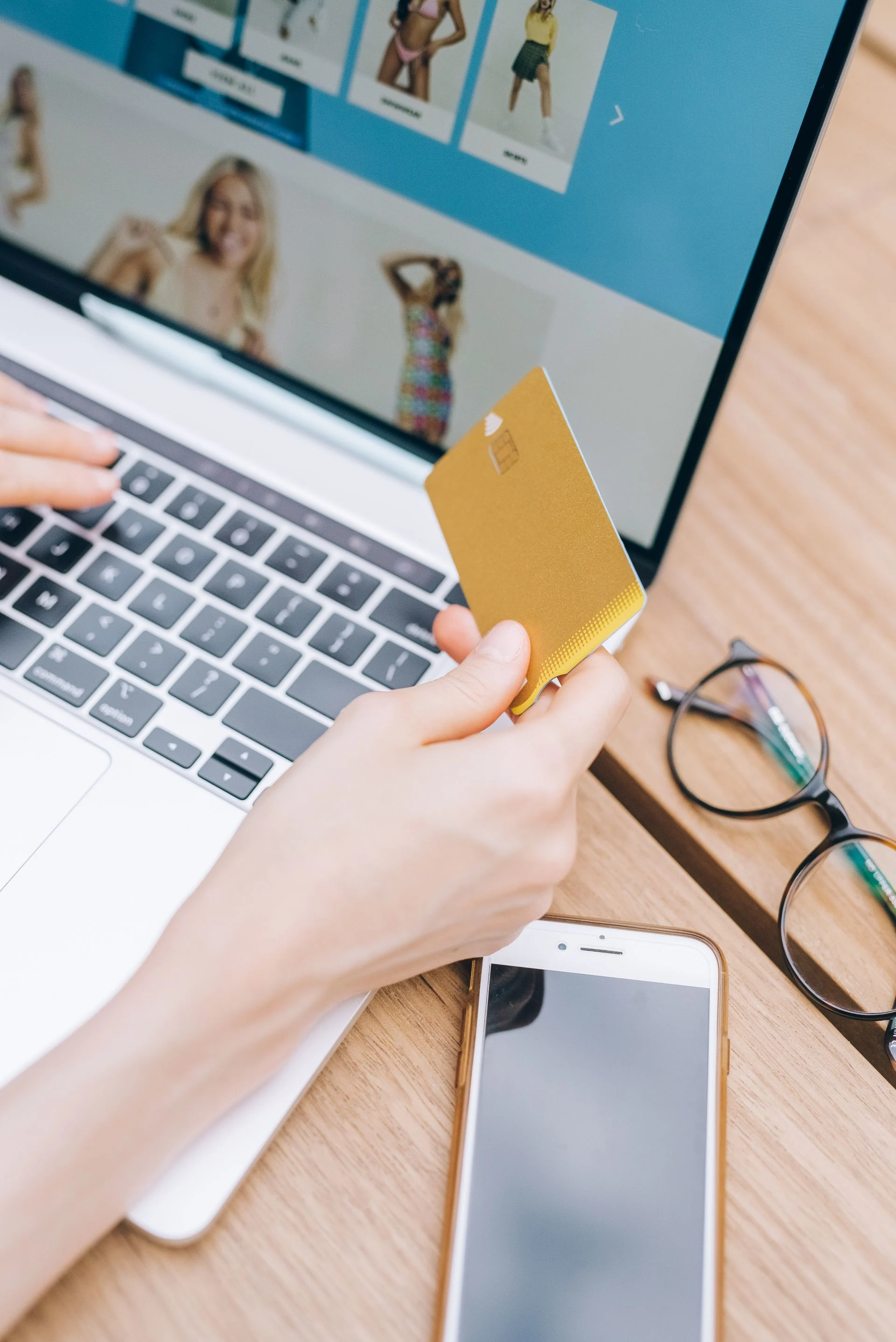 Close-up of woman shopping online using a credit card on a laptop. Photo by Leeloo The First via Pexels.com