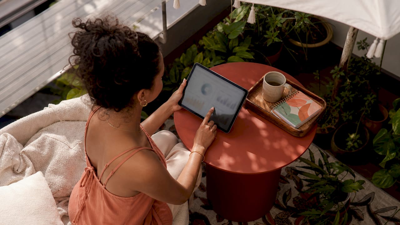 Hands using tablet financial dashboard app
