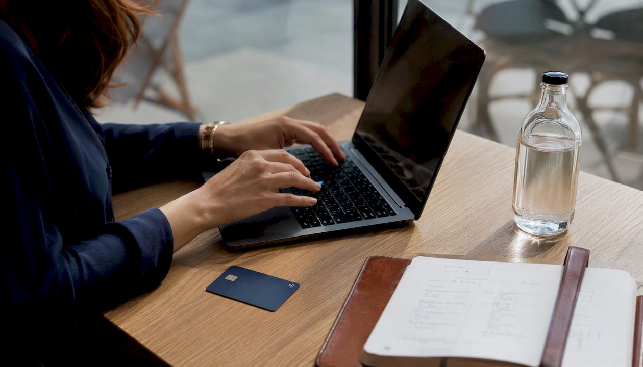 Hands adjusting automated savings on laptop
