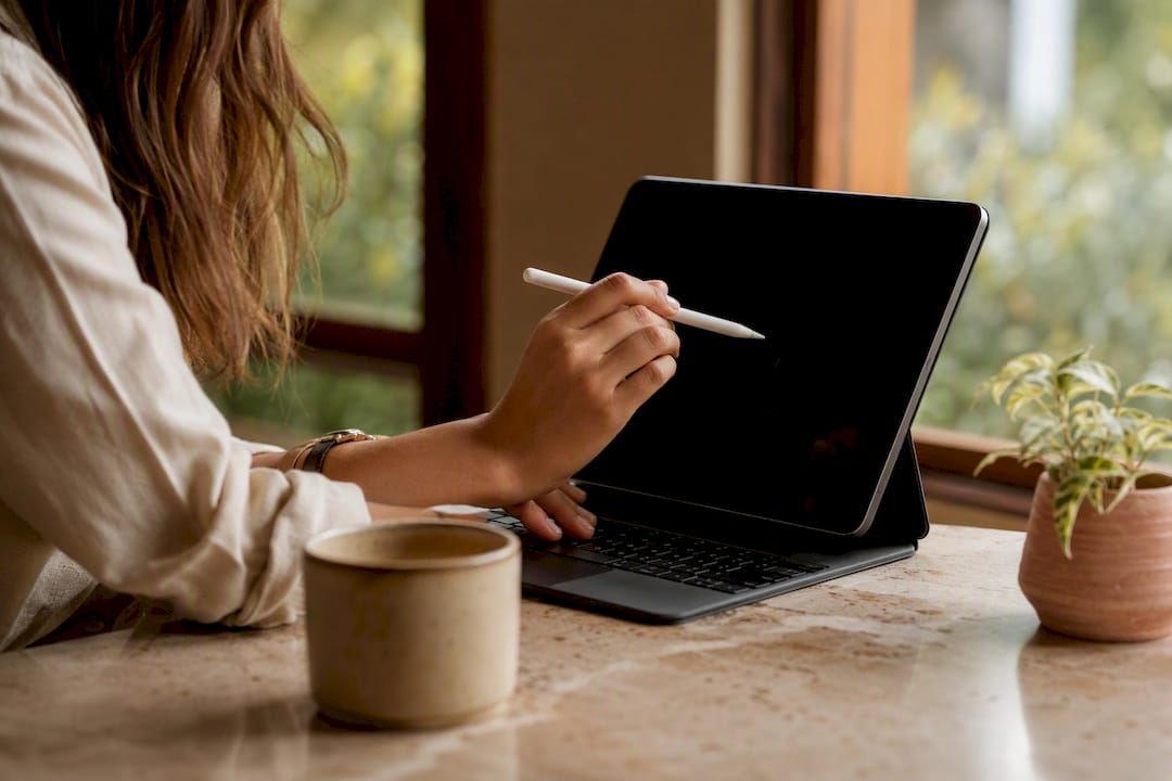 Hands adjusting financial spreadsheet on laptop keyboard