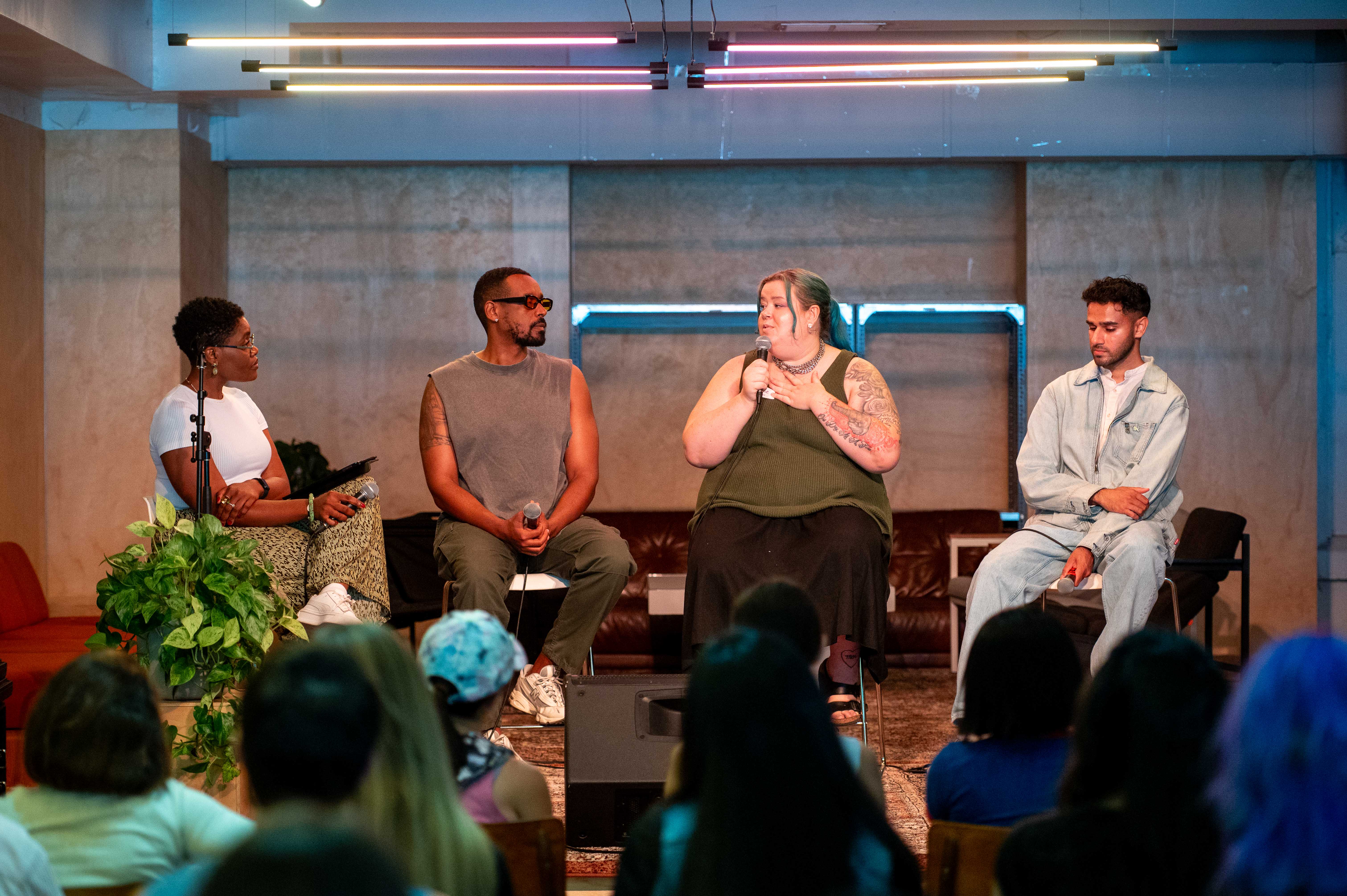 Group of panelists seated in a circle, actively discussing topics during a panel discussion.