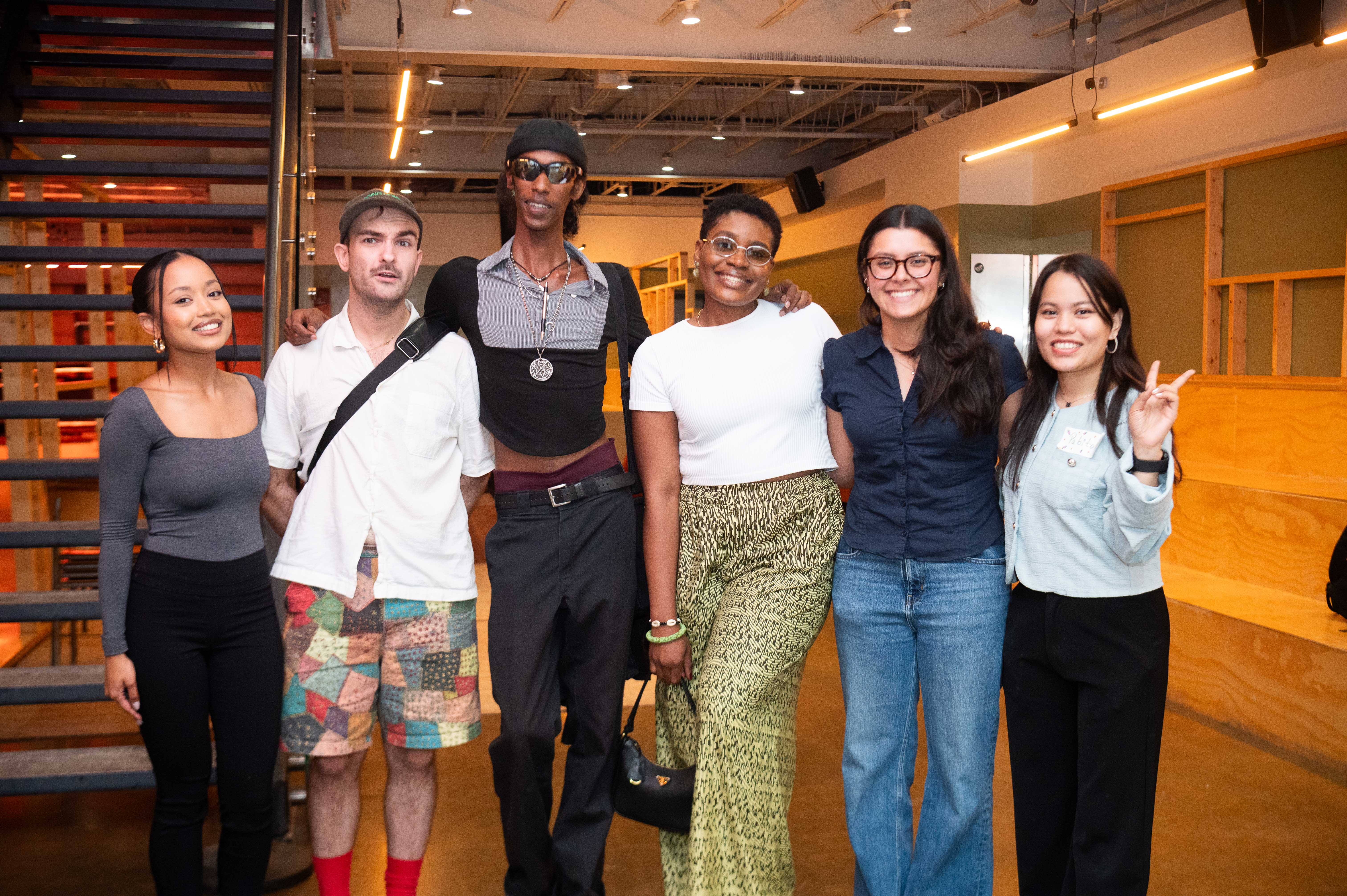 Image of the event where seven people are sitting at a round table and having a discussion