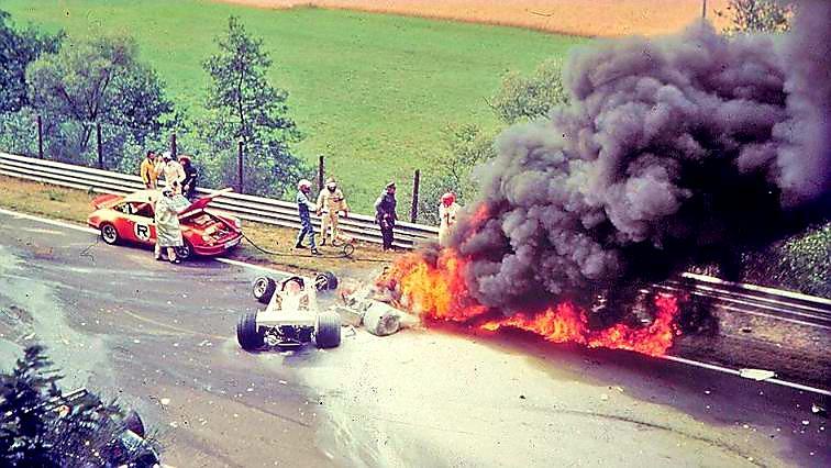 A race car on fire with people watchingAI-generated content may be incorrect.
