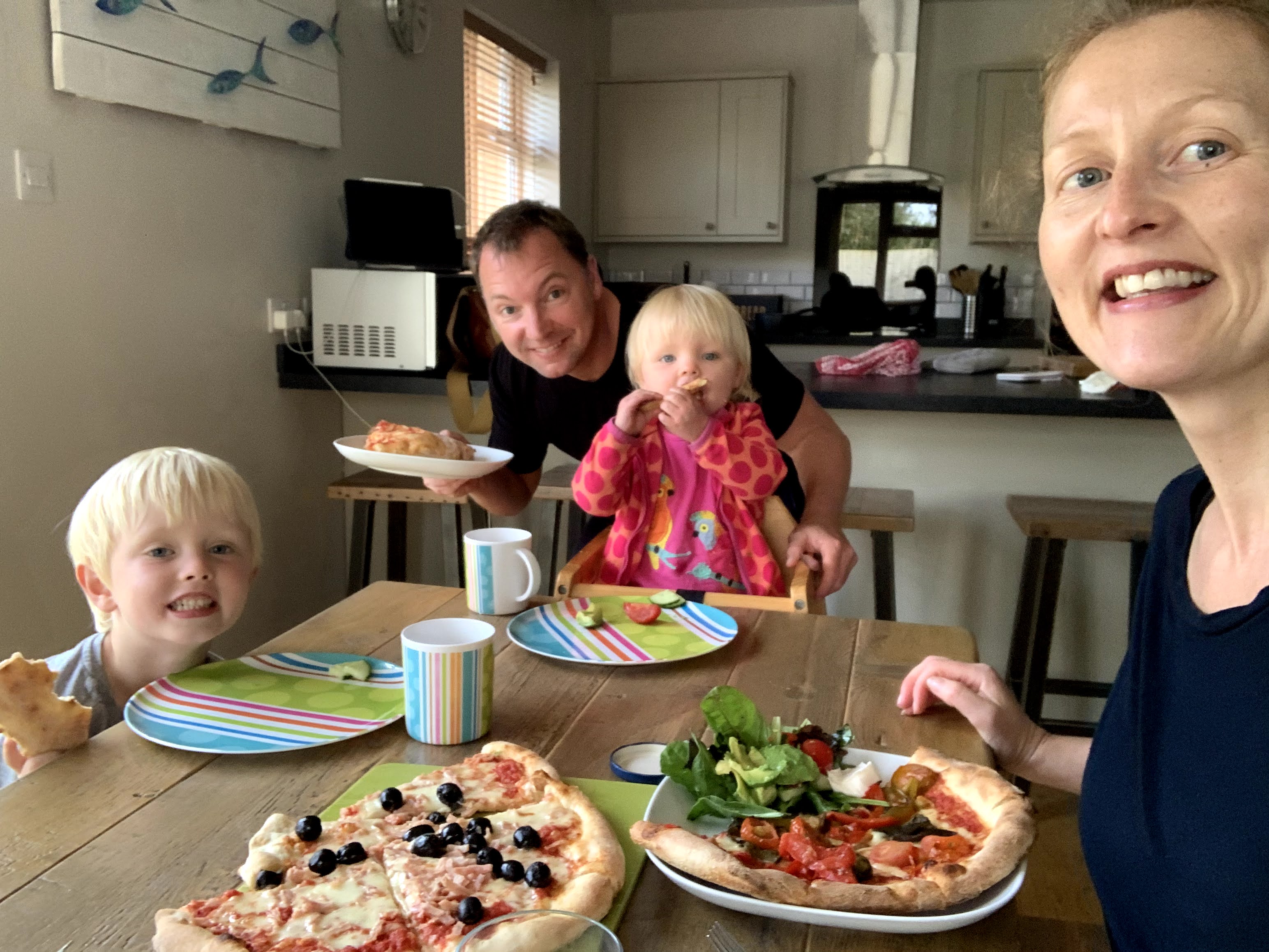 Family enjoy dinner at child-friendly Gwelmor self-catering holiday cottage in Widemouth Bay, north Cornwall