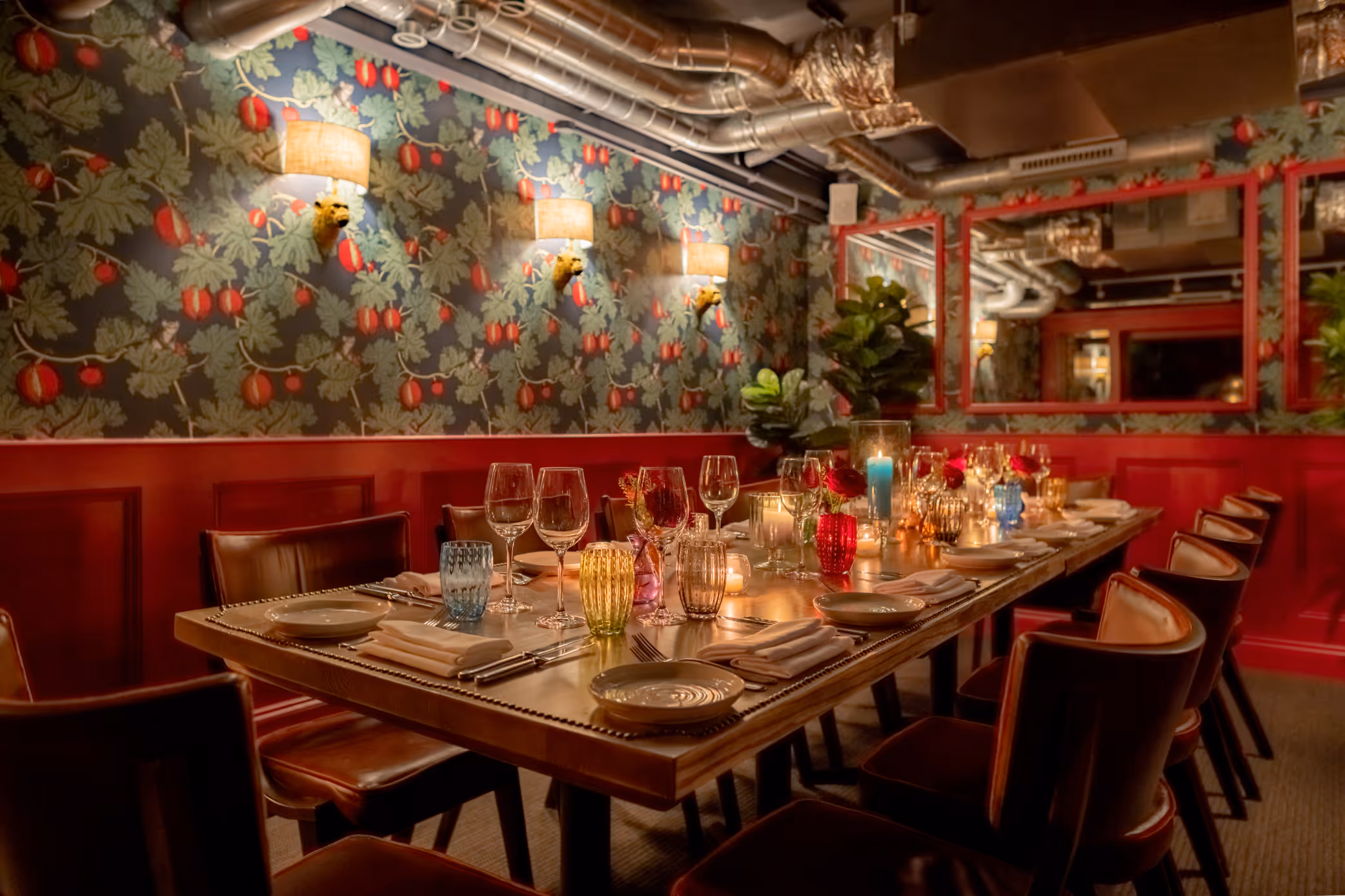 A fully laid -up table in The Private Room at Stanley's Chelsea with a floral illustrated border