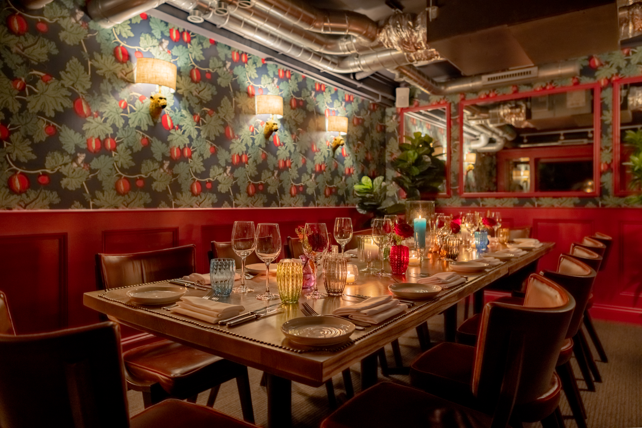 A fully laid -up table in The Private Room at Stanley's Chelsea with a floral illustrated border